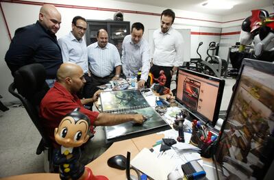Suleiman Bakhit (front) discusses on his games paints with (from L to R): Afif Toukan, Mohammad Haj Hasan, Muhannad Ebwini, Nour Khrais and Suhaib Thiab, at his office in Amman, Jordan on June 08, 2010. (Salah Malkawi for The National)