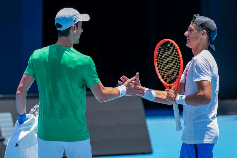 Novak Djokovic shakes hands with Argentina's Federico Coria following a practice session. AP