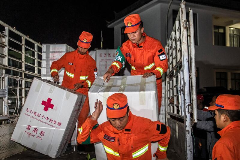 Rescue personnel bring emergency supplies to residents of Yangbi county, the epicentre of an earthquake in China's Yunnan province. AP Photo