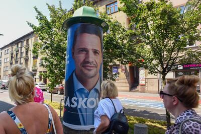 KRAKOW, POLAND - JUNE 26: Women walk by a campaign poster of Rafal Trzaskowski, the Mayor of Warsaw and presidential candidate for the centre-right main opposition party, Civic Coalition (KO) on the last campaign day before Sunday's Presidential elections on June 26, 2020 in Krakow, Poland. Recent polling suggests current President Andrzej Duda may not claim enough votes to win in the first round, and could face a run-off election with Warsaw's liberal mayor, Rafal Trzaskowski. (Photo by Omar Marques/Getty Images)