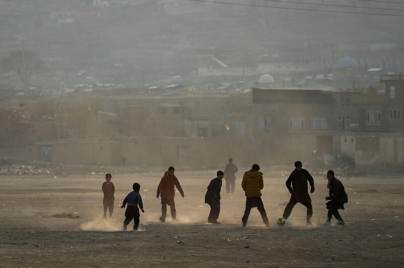 Afghan youths play football at an esplanade at Shuhada Lake in Kabul. AFP