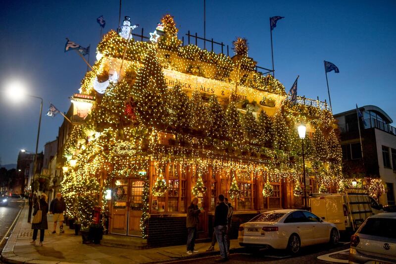 LONDON, ENGLAND - DECEMBER 15: Christmas trees and fairy lights adorn the exterior of the Churchill Arms pub, ahead of London being moved into â€˜Tier 3â€™ of the pandemic-control system on Wednesday,  on December 15, 2020 in London, England. In 'Tier 3' of England's pandemic-control measures, restaurants and pubs will be limited to takeaway and delivery, although shops are allowed to remain open. (Photo by Peter Summers/Getty Images)