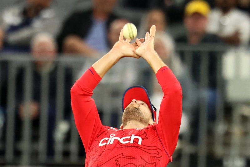 England's Dawid Malan takes a catch to dismiss Australia batter Marcus Stoinis for 35. AFP