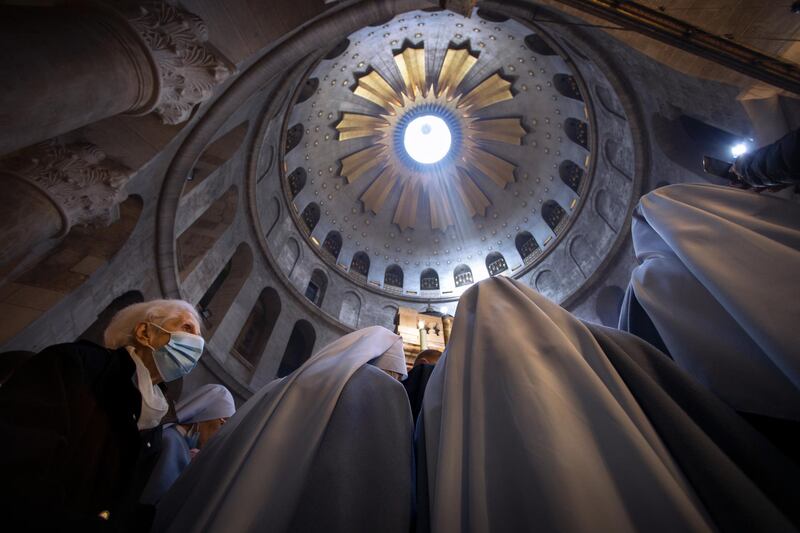 A woman attends Easter Sunday mass led by Latin Patriarch of Jerusalem Pierbattista Pizzaballa at the Church of the Holy Sepulchre, Jerusalem. AP Photo