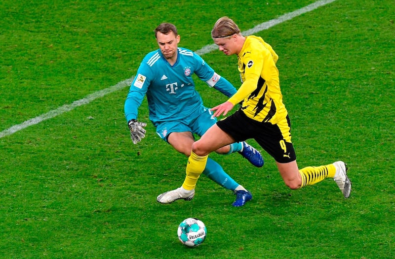 Dortmund forward Erling Braut Haaland rounds Bayern goalkeeper Manuel Neuer to score his team's second goal. AFP