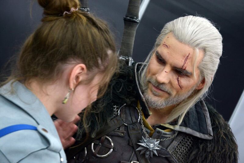 German cosplayer Maul, portraying the character Geralt of Rivia from The Witcher 3 video game, meets a fan during the 2019 Cyprus Comic-Con in the capital Nicosia. AFP