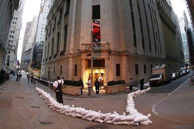Sandbags are placed around the perimeter of the New York Stock Exchange as Hurricane Sandy looms on the horizon. US stock exchanges were closed yesterday and may remain so today. Carlo Allegri / Reuters