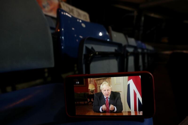LUTON, ENGLAND - SEPTEMBER 22: A stream of Boris Johnson's address to the nation is seen on a phone during the Carabao Cup Third Round match between Luton Town and Manchester United at Kenilworth Road on September 22, 2020 in Luton, England. Sporting Stadiums around Europe remain empty due to the Coronavirus Pandemic as Government social distancing laws prohibit fans inside venues resulting in games being played behind closed doors (Photo by Catherine Ivill/Getty Images)
