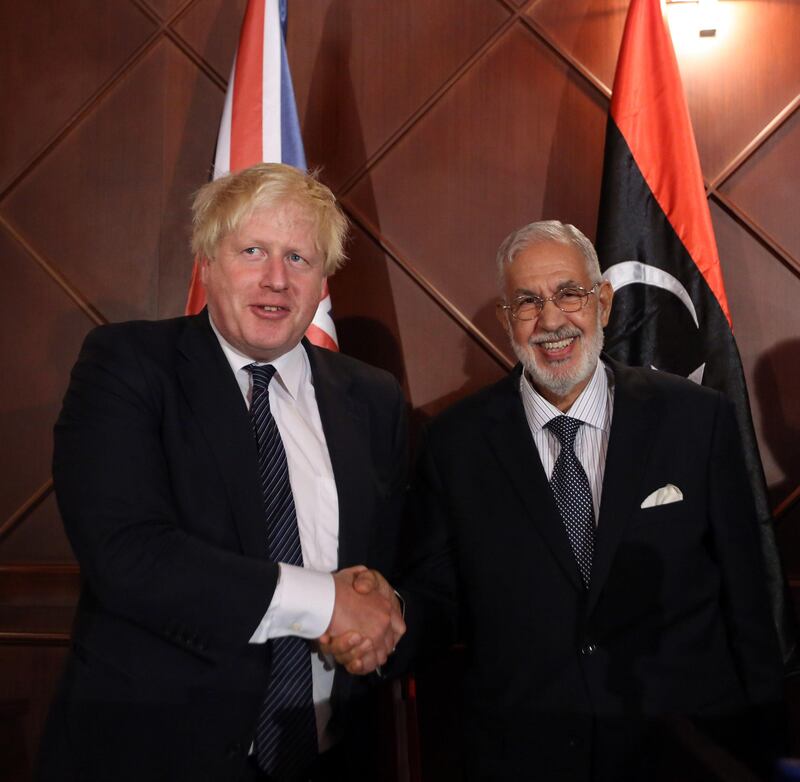 British Foreign Minister Boris Johnson (L) shakes hands with Mohamed al-Taher Siala, Foreign Minister of the UN-backed Libyan Government of National Accord, during a press conference in the capital Tripoli on August 23, 2017. / AFP PHOTO / STR