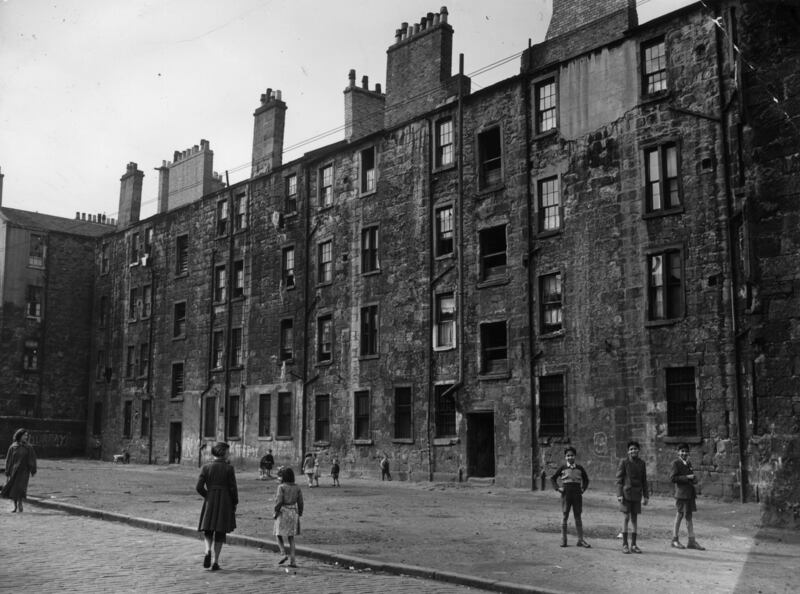 Children play in a yard in Coburg Street, in the Gorbals area of Glasgow in 1956. The Gorbals tenements were built quickly and cheaply in the 1840s, providing housing for Glasgow's burgeoning population of industrial workers. Getty Images