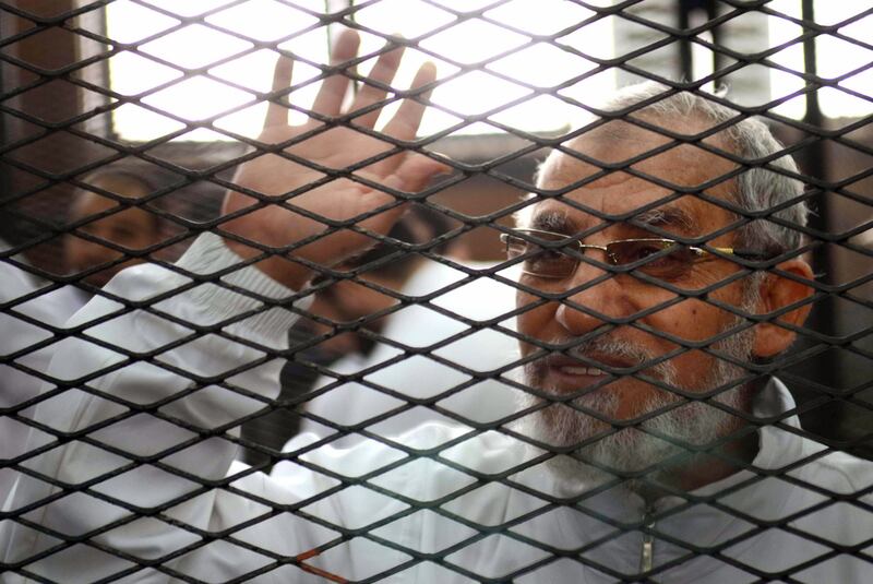 Mohammed Badie inside the defendants cage during the trial of Muslim Brotherhood members in 2014. AFP