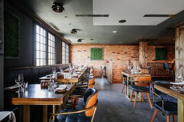 The interior decor of exposed brick and wood works at Folly by Nick and Scott, which has replaced Rivington Grill. Courtesy Folly by Nick and Scott 