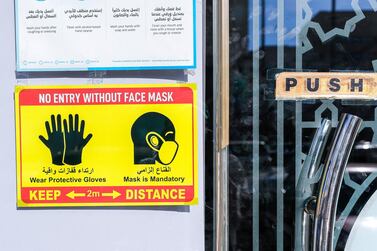 A Covid-19 safety sign on Al Qahirah street, Abu Dhabi, reminds people of restrictions. Victor Besa / The National 