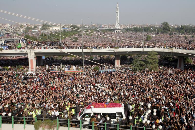 People chant slogans as they gather near an ambulance carrying the body of Khadim Hussain Rizvi, leader of religious and political party Tehreek-e-Labaik Pakistanduring the funeral service.  Reuters