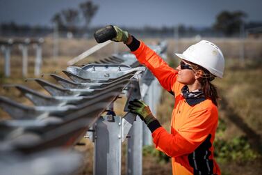 A worker checks newly constructed metal frames for photovoltaic modules at a solar farm on the outskirts of Gunnedah, New South Wales, Australia, April 16. Most Australians would prefer investment in clean energy to help lift the economy out of its Covid-induced recession to the government’s plan for a "gas-fired" recovery. Bloomberg