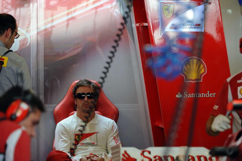 Ferrari's Spanish driver Fernando Alonso sits in the pits during the first practice session at the Yas Marina circuit in Abu Dhabi on November 2, 2012 ahead of the Abu Dhabi Formula One Grand Prix. AFP PHOTO/TOM GANDOLFINI
 *** Local Caption ***  804838-01-08.jpg