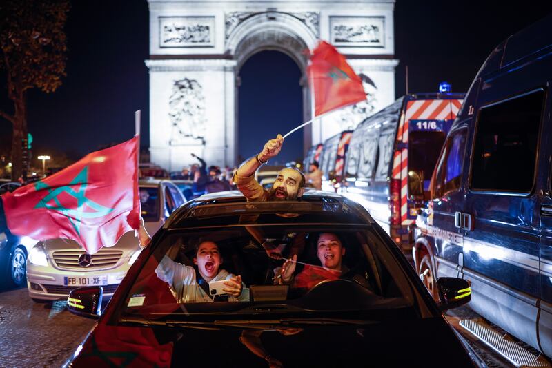 Moroccan supporters in Paris celebrate after their team advanced to the quarter-finals of the tournament. EPA