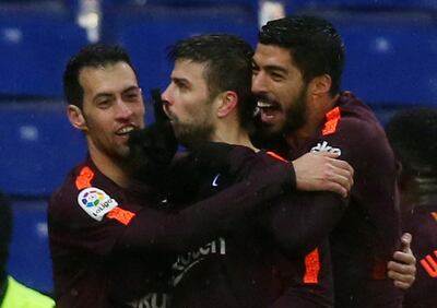 Soccer Football - La Liga Santander - Espanyol vs FC Barcelona - RCDE Stadium, Barcelona, Spain - February 4, 2018   Barcelona’s Gerard Pique celebrates with Sergio Busquets and Luis Suarez after scoring their first goal    REUTERS/Albert Gea