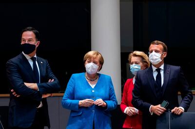 TOPSHOT - Netherlands' Prime Minister Mark Rutte (L) looks on next to Germany's Chancellor Angela Merkel ( 2nd L), President of the European Commission Ursula von der Leyen (2nd R) and France's President Emmanuel Macron prior the start of the European Council building in Brussels, on July 18, 2020, as the leaders of the European Union hold their first face-to-face summit over a post-virus economic rescue plan. The EU has been plunged into a historic economic crunch by the coronavirus crisis, and EU officials have drawn up plans for a huge stimulus package to lead their countries out of lockdown.
 / AFP / POOL / Francisco Seco
