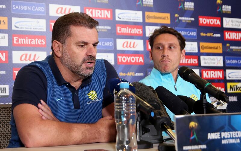 Australia's soccer head coach Ange Postecoglou, left, and player Mark Milligan discuss their pending Soccer World Cup qualifying match against Syria in Sydney, Australia, Monday, Oct. 9, 2017. Australia and Syria will play Tuesday in Sydney. (AP Photo/Rick Rycroft)