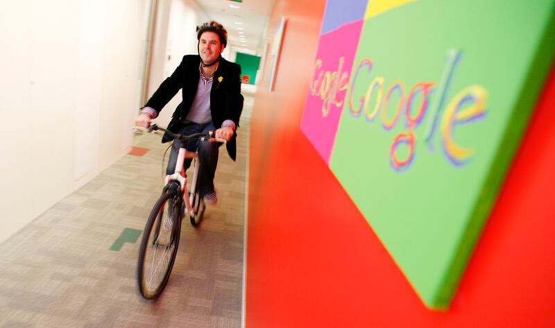 An employee rides his new Google-branded bike in 2007 in London. Google improved its green credentials by offering all staff a free bike to ride to work. Getty Images