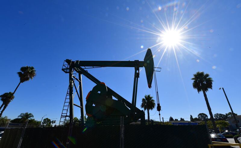 (FILES) In this file photo taken on October 21, 2019 A pumpjack from California-based energy company Signal Hill Petroleum is seen in front of the landmark Curley's Cafe, one of two pumpjacks in the Diner's parking lot which has been churning out oil from the ground below since 1921 in Signal Hill, California on October 21, 2019.  Despite the coronavirus pandemic that is devastating the world economy and oil demand, crude oil production continues at full steam, particularly in Saudi Arabia and the United States, pushing storage capacity to its limits.
 / AFP / Frederic J. BROWN / TO GO WITH AFP STORY BY KEVIN TRUBLET
