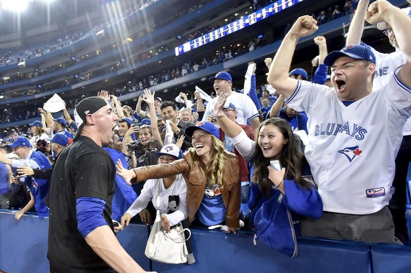 Toronto Blue Jays player Aaron Sanchez celebrates with fans after the team's win in Game 5 of the ALDS on Wednesday night to advance past the Texas Rangers. Nathan Denette / The Canadian Press / AP