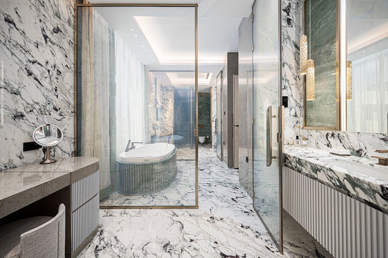 Bright breccia capraia stone marble in-laid with rare emerald quartz in the master bathroom