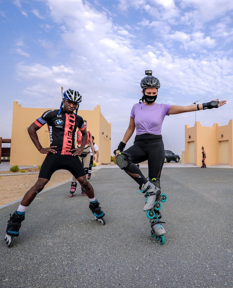 Abu Dhabi, United Arab Emirates, August 21, 2020.   The Madrollers skating group at the Al Wathba Bicycle Track do a  8 km. fun sprint.
  The skating group has members from Dubai and Abu Dhabi.  They encourage safety and discipline on roller-skates, skateboard, long-board and bicycles.  --Rollerbladers do limbering exercises before going on the 8 km fun sprint.
Victor Besa /The National
Section:  Photo Project
Reporter:
