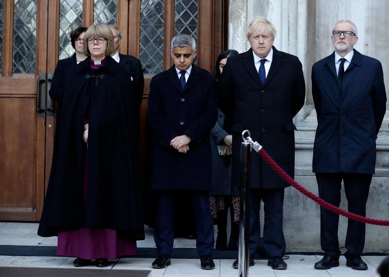 Britain's Prime Minister Boris Johnson, second right, Labour Party leader Jeremy Corbyn, right, and Mayor of London Sadiq Khan take part in a vigil at Guildhall Yard in London, Monday Dec. 2, 2019, to remember the London attack victims and honor members of the emergency services and bystanders who fought the attacker. London Bridge reopened to cars and pedestrians Monday, three days after a man previously convicted of terrorism offenses stabbed two people to death and injured three others before being shot dead by police. (AP Photo/Matt Dunham)