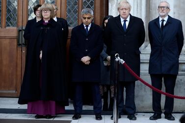 Britain's Prime Minister Boris Johnson, second right, Labour Party leader Jeremy Corbyn, right, and Mayor of London Sadiq Khan take part in a vigil at Guildhall Yard in London to remember the London attack victims. AP Photo/Matt Dunham