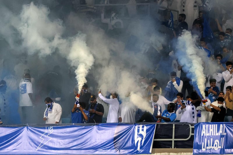 Hilal supporters let off blue and white flares in celebration. AFP