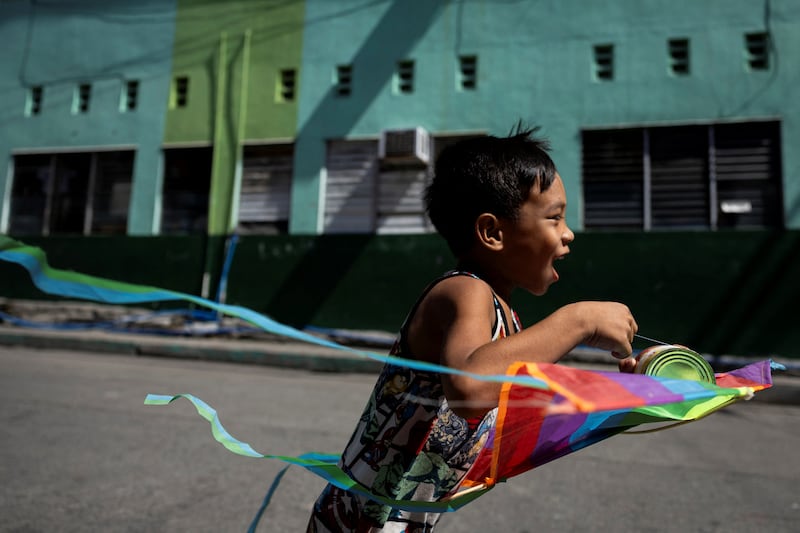 A boy runs with a kite in Valenzuela, the Philippines. Reuters