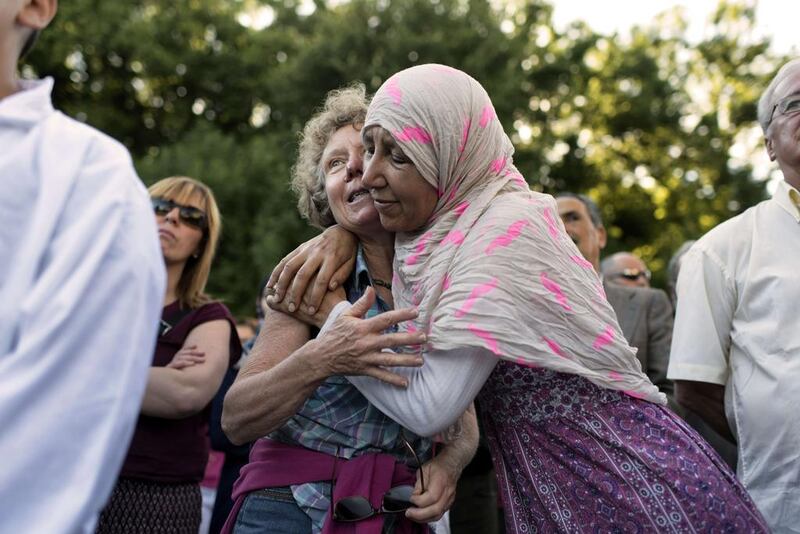 Women embrace on June 28, 2015, in front of the Mosque of Villefontaine in France, where about 300 people gathered  to ‘condemn the attack’ of the man who drove a van into a warehouse packed with dangerous gases in the neighbourding town of Saint-Quentin-Fallavier in an apparent bid to blow up the factory. Omain Lafabregue / Agence France-Presse