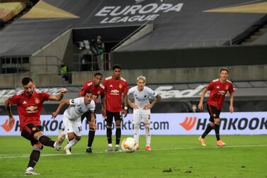 Manchester United's Bruno Fernandes scores his sides first goal from a penalty kick during the UEFA Europa League quarterfinal soccer match between Manchester United and FC Copenhagen in Cologne, Germany, Monday, Aug. 10, 2020. (Wolfgang Rattay/Pool via AP)