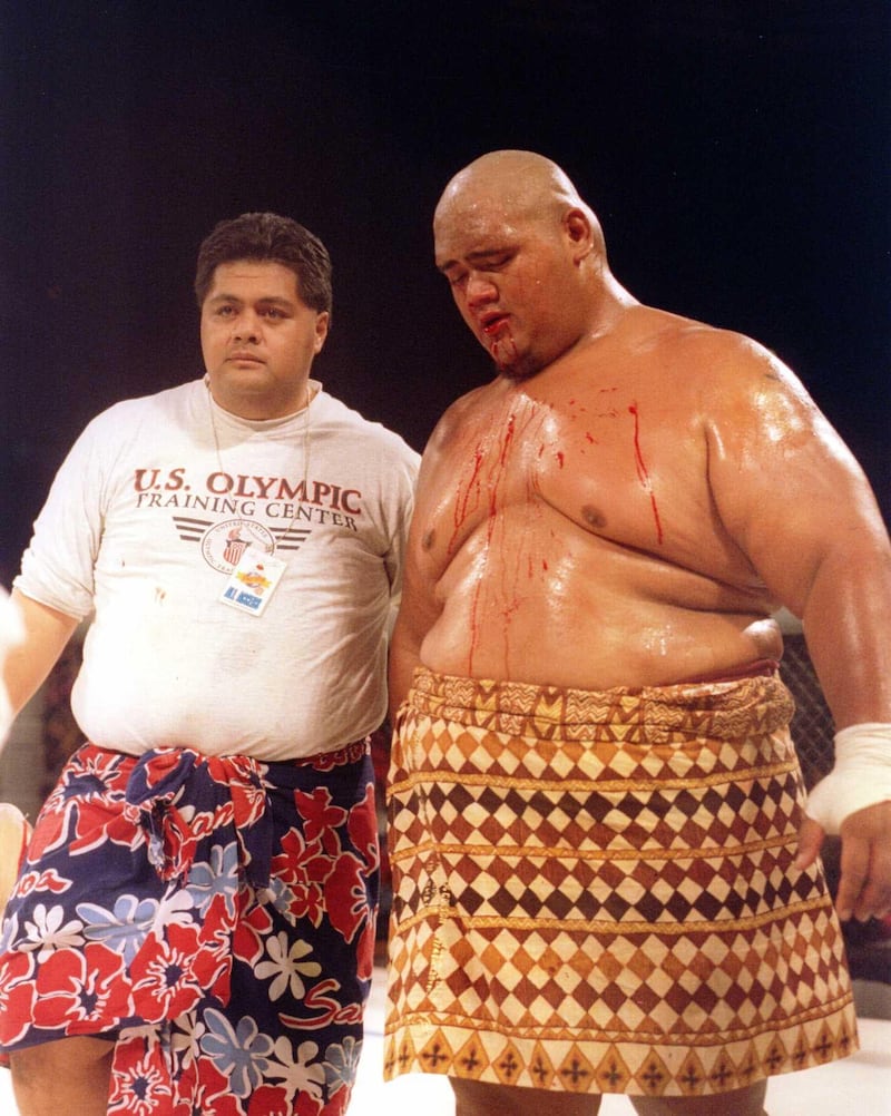 His chest splattered with blood, Sumo wrestler Teilo Tuli of Honolulu, HA is escorted to his corner after receiving a fight ending blow thrown by Gerard Gordeau during the Ultimate Fighter Championships in Denver, Colorado. Mandatory Credit: Markus Boesch / Getty Images
