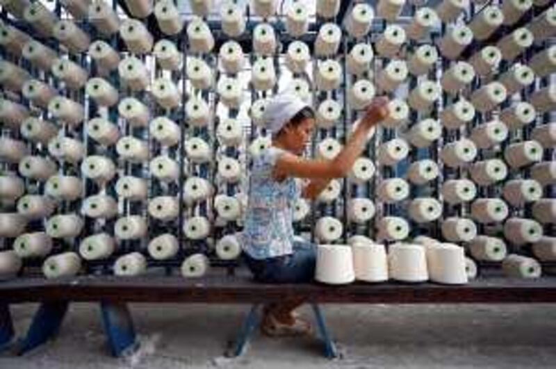 An employee works at a textile factory in Suining, Sichuan province September 11, 2009. Chinese industrial output and other economic data surprised on the upside in August, suggesting its recovery is on a solid course but not so strong that Beijing will need to hit the policy brakes anytime soon.  REUTERS/Stringer (CHINA BUSINESS IMAGES OF THE DAY) CHINA OUT. NO COMMERCIAL OR EDITORIAL SALES IN CHINA *** Local Caption ***  PEK11_CHINA-ECONOMY_0911_11.JPG *** Local Caption ***  PEK11_CHINA-ECONOMY_0911_11.JPG