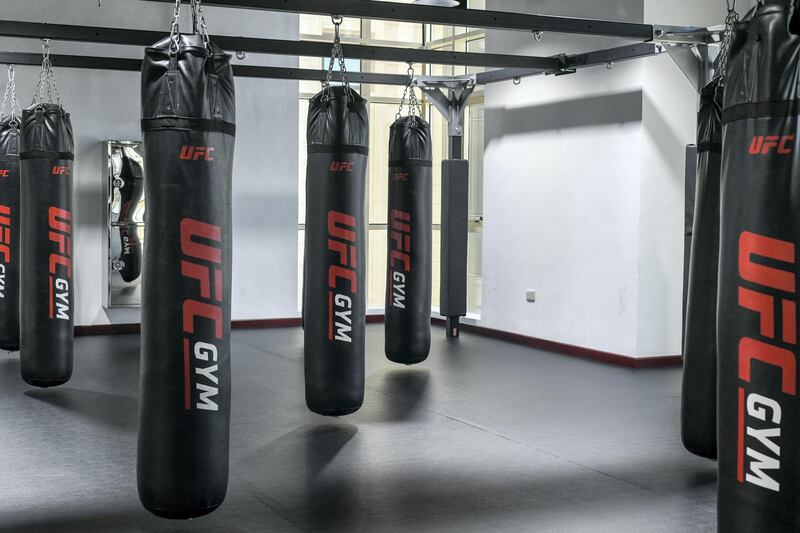 Abu Dhabi, United Arab Emirates - Signature Mix Martial Arts and Brazilian Jiu-Jitsu room on the first level with 17 punching bag racks at the UFC Gym in Mohammed Bin Zayed City. Khushnum Bhandari for The National