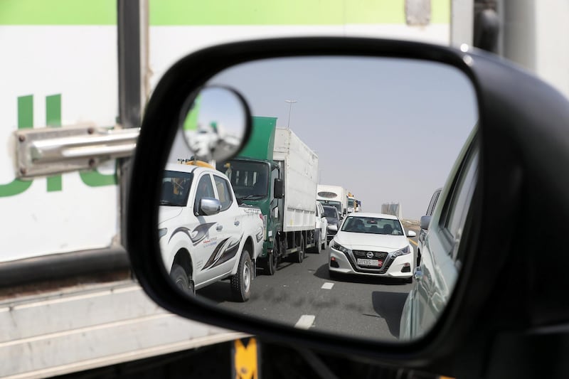 DUBAI, UNITED ARAB EMIRATES , June 2 – 2020 :- Traffic jam at the Dubai border going towards Abu Dhabi on Sheikh Zayed road in Dubai. Abu Dhabi Police checking the movement permits at the police checkpoint on the Dubai – Abu Dhabi border on Sheikh Zayed road in Dubai. Abu Dhabi impose one week ban starting from Tuesday on travel on entering and leaving the emirate to reduce the spread of Covid-19  and ensure its huge testing drive works. (Pawan Singh / The National) For News/Online 