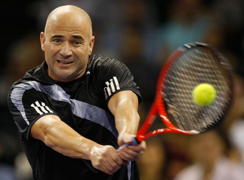 Andre Agassi, shown here returning the ball to Pete Sampras during a friendly exhibition in 2009, is considering to become the ATP's next 'super coach' but has not fully committed to the idea just yet. AP Photo/Vincent Yu