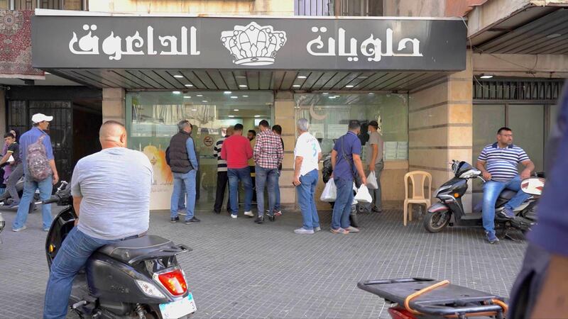 People gathering outside Daouk sweet shop to buy Daoukiye before the iftar time. Mahmoud Rida / The National