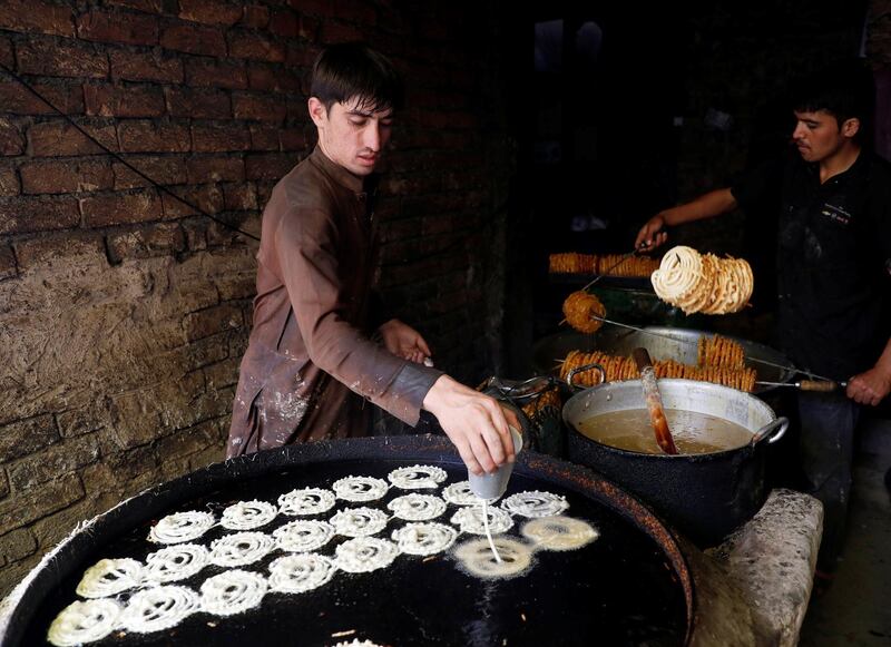Afghan men make sweets at a small traditional factory ahead of the Eid al-Adha in Kabul, Afghanistan. Reuters