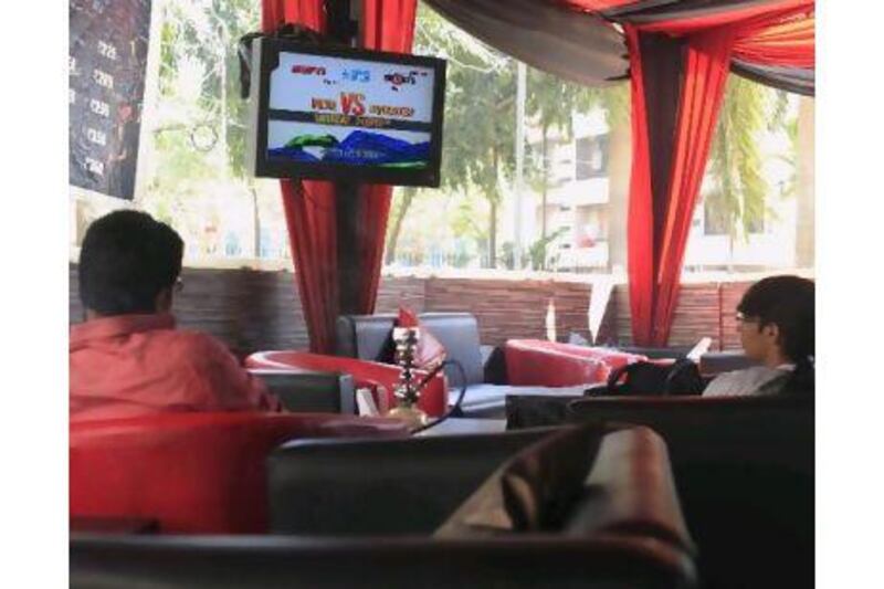 Young cricket fans in a Mumbai cafe; a Pepsi advertisement for the ICC Cricket World Cup; and a screen erected by Hyundai to showcase its brand in conjunction with the World Cup.