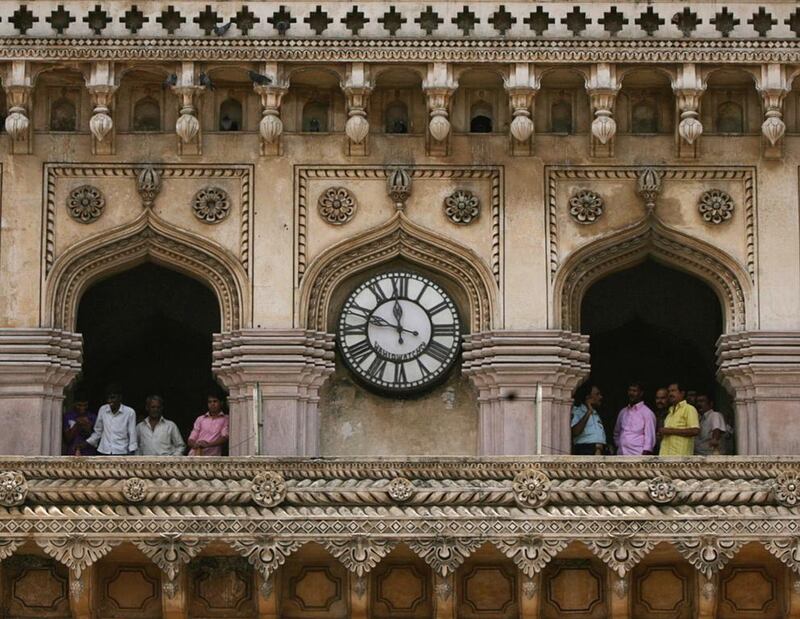 Tourists stand at the historical monument Charminar in the southern Indian city of Hyderabad. Krishnendu Halder/Reuters