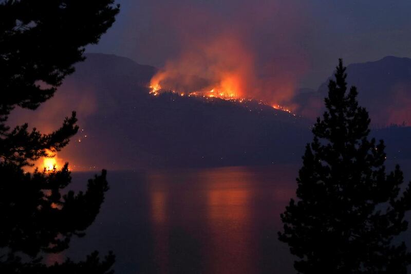 A wildfire burns off the shore of Jackson Lake in Grand Teton National Park, Wyoming. Brennan Linsley / AP Photo