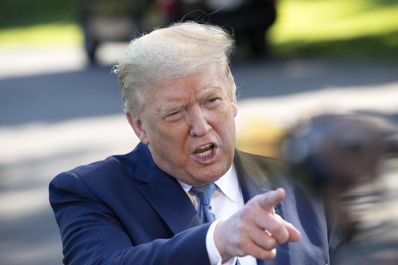 U.S. President Donald Trump speaks to members of the media on the South Lawn of the White House in Washington, D.C., U.S., on Friday, May 15, 2020. Trump's choice to lead the agency in charge of Voice of America is the subject of an investigation by the Washington, D.C. attorney general’s office, adding another hurdle to a nomination that's been stalled for two years. Photographer: Stefani Reynolds/CNP/Bloomberg