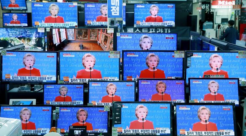 TV screens show the live broadcast of Democratic presidential nominee Hillary Clinton during the US presidential debate with Republican presidential nominee Donald Trump, in Seoul, South Korea. Hong Hae-in / Yonhap via AP