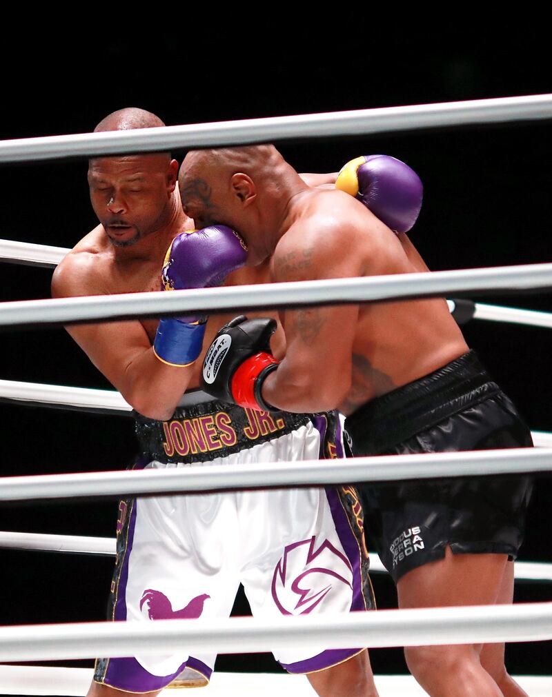 Mike Tyson and Roy Jones, Jr. trade punches during their heavyweight exhibition boxing bout. Reuters