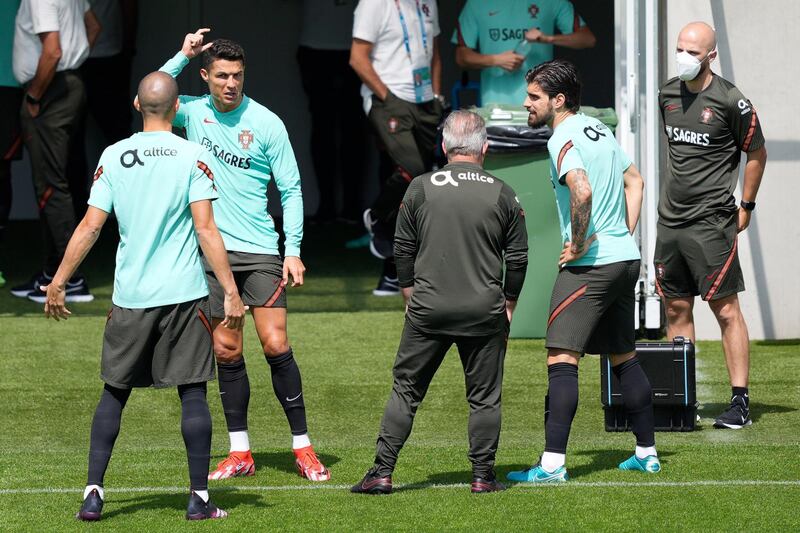 Cristiano Ronaldo speaks to players and staff during a training session at Illovszky Rudolf Stadium. EPA