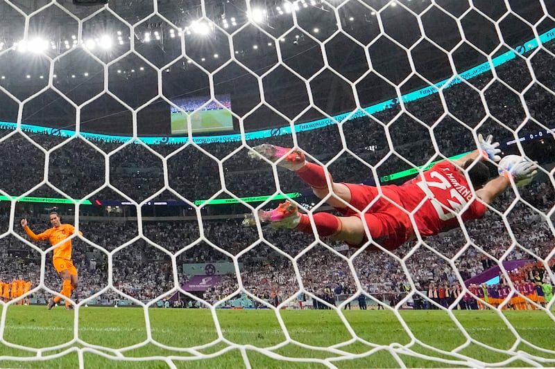 Argentina goalkeeper Emiliano Martinez saves from Virgil van Dijk of the Netherlands in the penalty shoot-out. AP